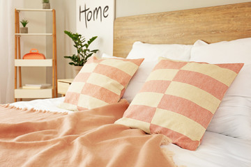 Stylish pillows on bed at home
