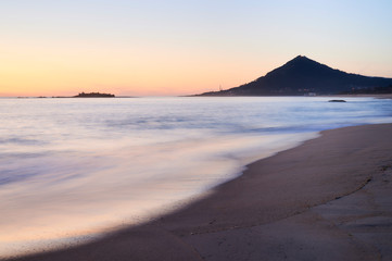 Sunset at the Moledo beach, with a mountain on backgroud