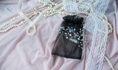 Wedding background with pearls and hair accessories on pink background