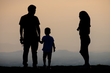 Fototapeta na wymiar Silhouette happy tourist family on the view point at sunset time.