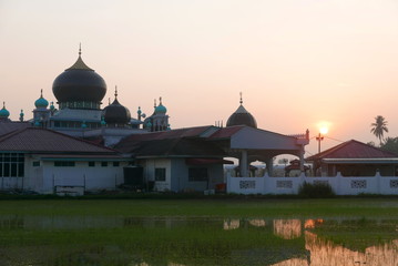 Sunrise of a mosque surrounding by paddy field in small village at Kedah,Malaysia.