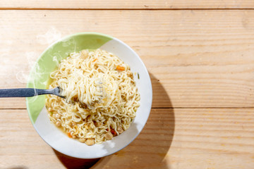 People eat the noodles with fork