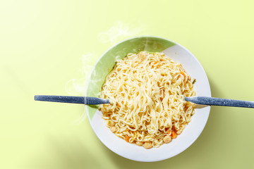 Noodles on the bowl with spoon and fork