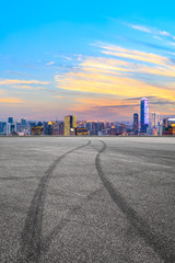 Empty race track and modern city skyline in Shanghai at sunset,China