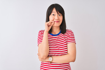 Young beautiful chinese woman wearing red striped t-shirt over isolated white background mouth and lips shut as zip with fingers. Secret and silent, taboo talking