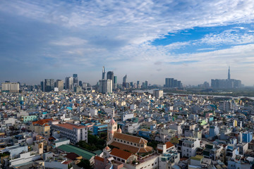 Fototapeta premium Arieal photography of Church, rooftops, architecture and view to City Skyline and River .Ho Chi Minh City Vietnam