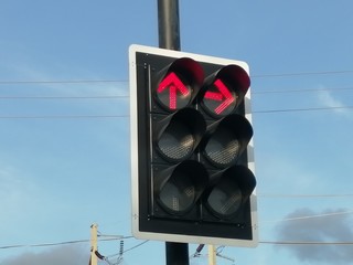 red traffic light on blue sky background