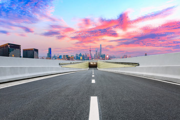 Fototapeta premium Empty asphalt highway and modern city skyline in Shanghai at sunset,China