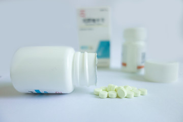 pills and bottle on white background
