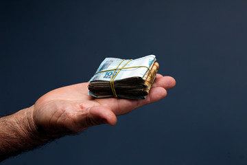Hands holding Brazilian real notes - Money from Brazil - Notes of Real - Brazil BRL banknote