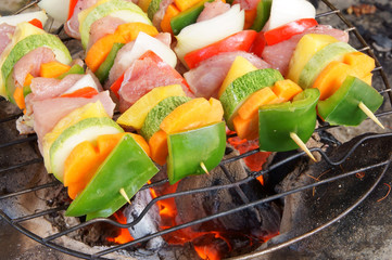 Barbecue food, grilled meat and vegetables on grid.
