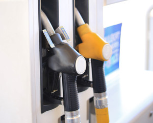 Close up gasoline station, gas pump nozzle, petrol station. Multi-colored handles two filling guns