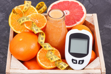 Glucometer, freshly blended coctail or smoothie made of citrus and centimeter. Diabetes, healthy...