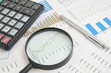 Business concept with charts, graphs and calculator