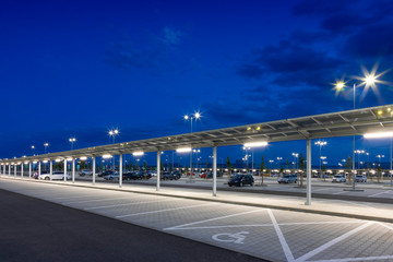 modern parking with covered pedestrian corridor at night