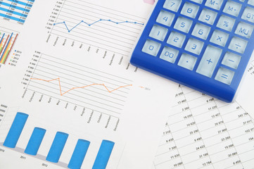 Business concept, calculator on financial charts and graphs