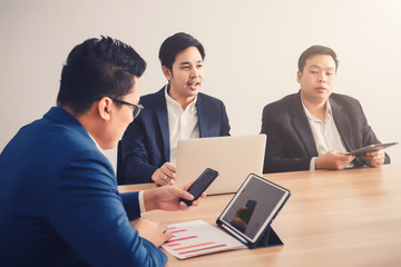 Fototapeta premium Businessman serching data with smartphone between meeting corporate success brainstorming