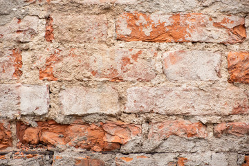 Ruined rough red brick wall