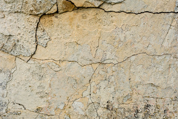 Texture of a concrete wall with cracks and scratches which can be used as a background