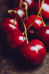 Ripe and juicy cherries on the dark rustic background. Selective focus. Shallow depth of field.