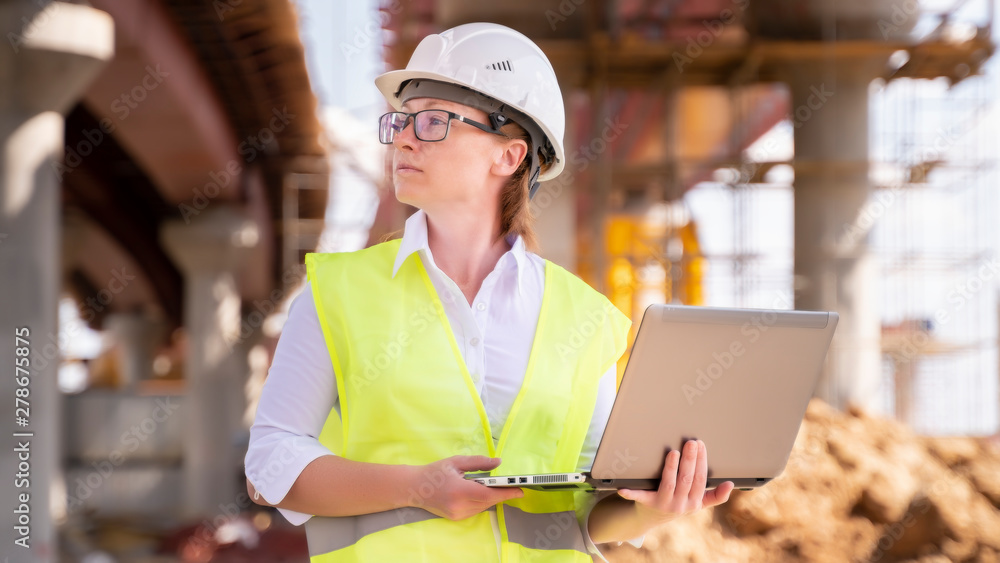 Wall mural female foreman inspects object at building site. construction of central ring car road.