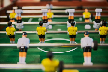 Table football, table football with close-ups of yellow and white players.