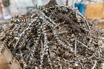 The collection of metal shavings into the container for reuse