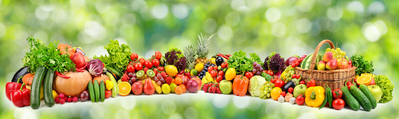 Ripe vegetables and fruits on natural green background