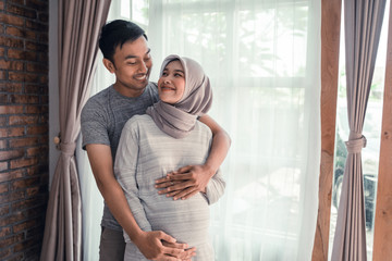 pregnancy muslim woman. happy asian romantic couple expecting baby