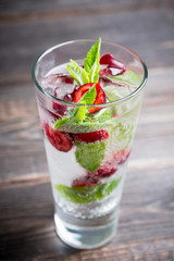 Cherry mojito cocktail on the rustic background. Selective focus. Shallow depth of field.