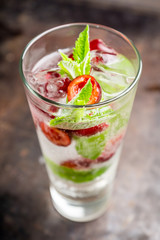 Cherry mojito cocktail on the rustic background. Selective focus. Shallow depth of field.
