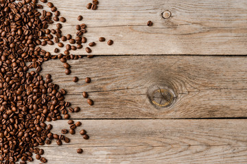 Coffee beans on an old wooden table.