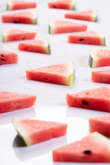 Slices of fresh watermelon on white marble background