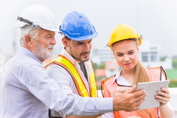 group of builder engineer and architecture using new technology of tablet for inspect building...