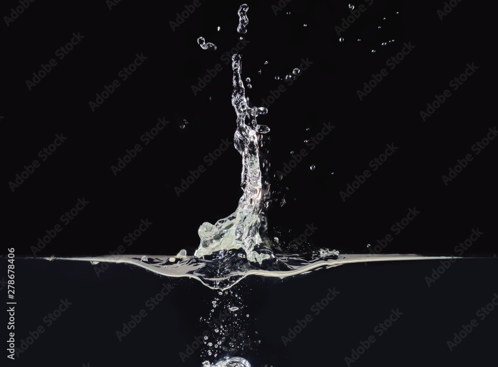 Poster explosion on liquid surface isolated on black background, close up view. water bubbles after splash,