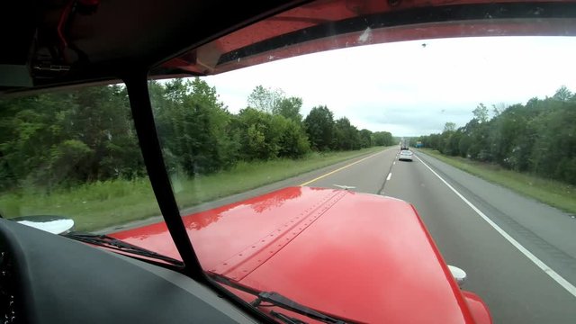Cutaway shot out the front window showing interstate roadway