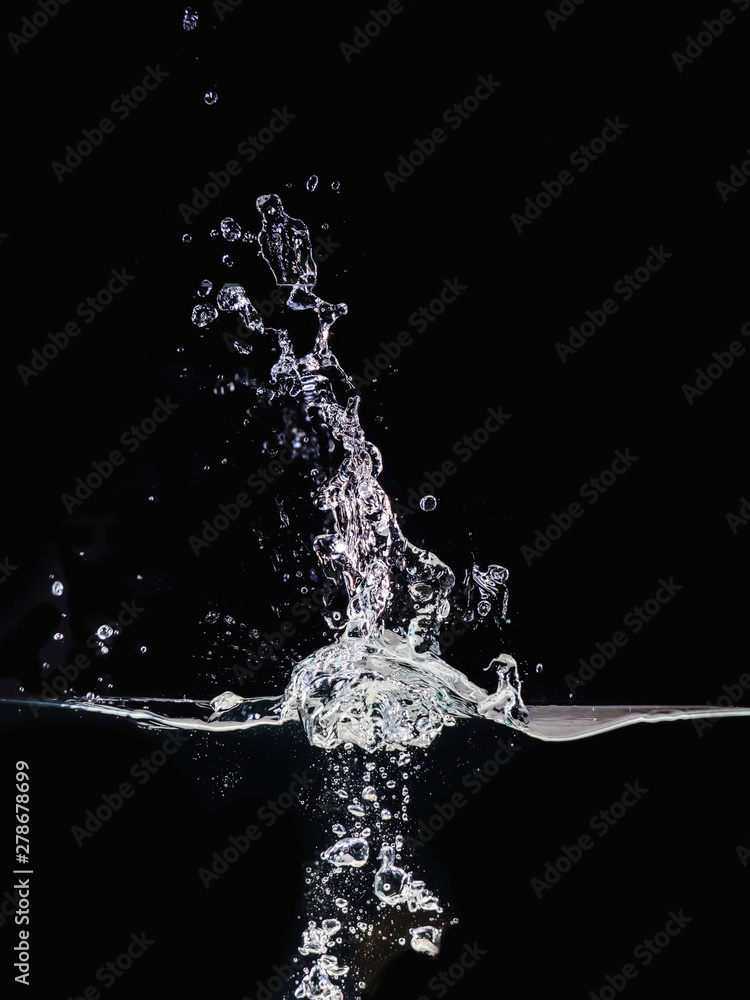 Poster water splash on surface isolated on black background, close up view. small water bubbles underwater 