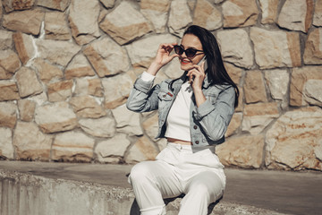 Beautiful Brunette Girl in Sunglasses White Pants and Jeans Jacket, Red Lipstick