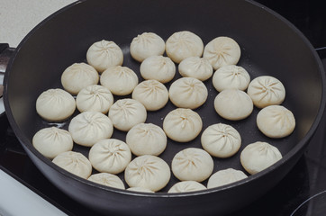 khinkali from dough with meat in a pan