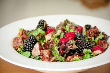 Salad bowl with grilled beef steak and berries