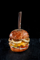 Homemade double cheese burger with onion ring.