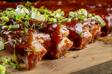 Pork ribs with sauce laid out on a wooden board-2.