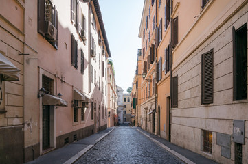 Narrow European street with stone road and old buildings
