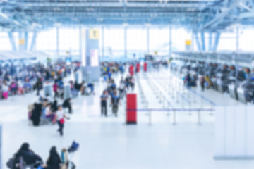 passenger walking at check-in area of airport terminal. blurred for background