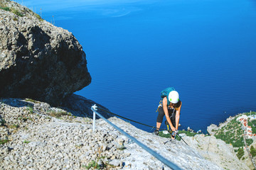 Woman climbing mountain. 