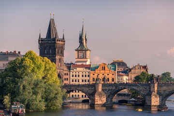 Fototapeta na wymiar Prague landmarks of Bridge Tower and Charles bridge at golden hour
