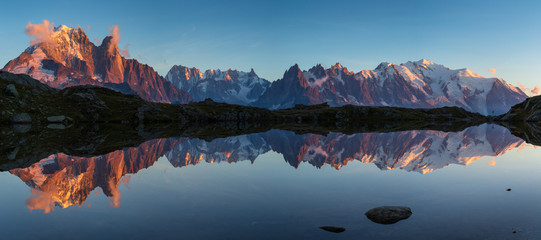 Panorama of the Mont Blanc massif reflected in Lac de Chesery during sunset. Chamonix, France. - Powered by Adobe