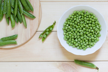 Green peas on wooden table with copy space