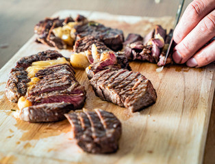 grilled steaks on the wooden board