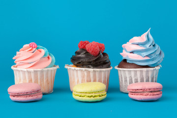 Birthday cupcakes on blue background close up